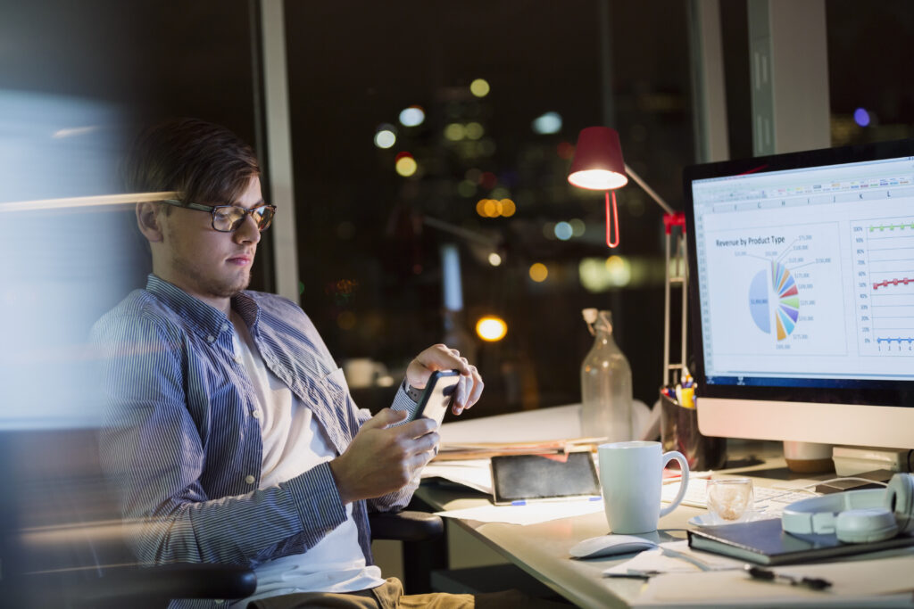 Businessperson with digital tablet working late in office