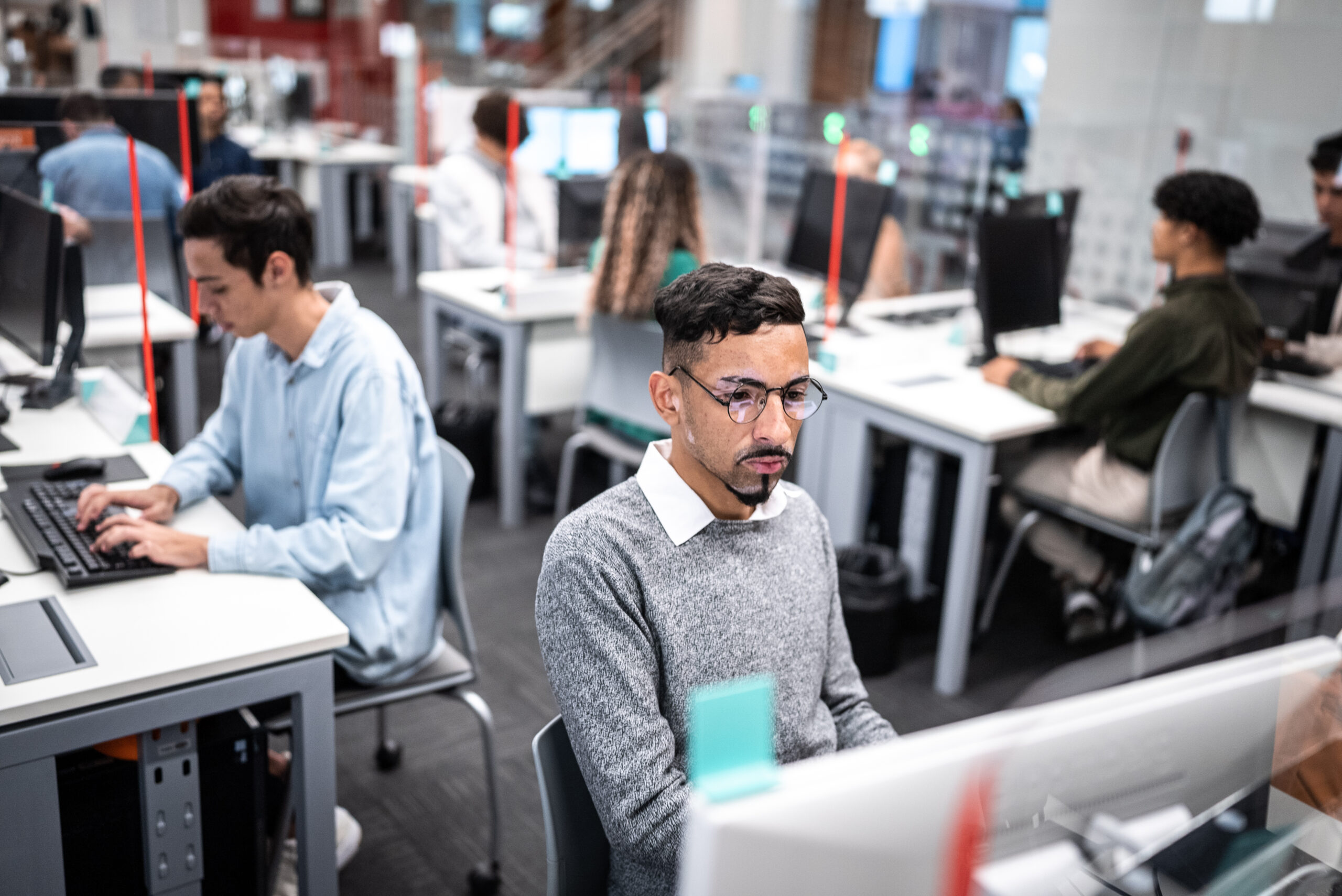 Tech analysts at desks in open office