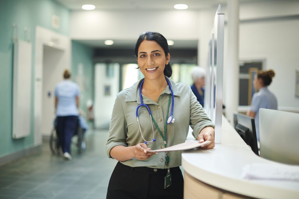 Heath care consultant holding chart in hospital lobby