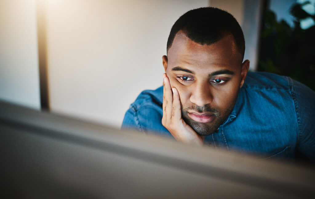 person-staring-at-laptop-screen-thinking