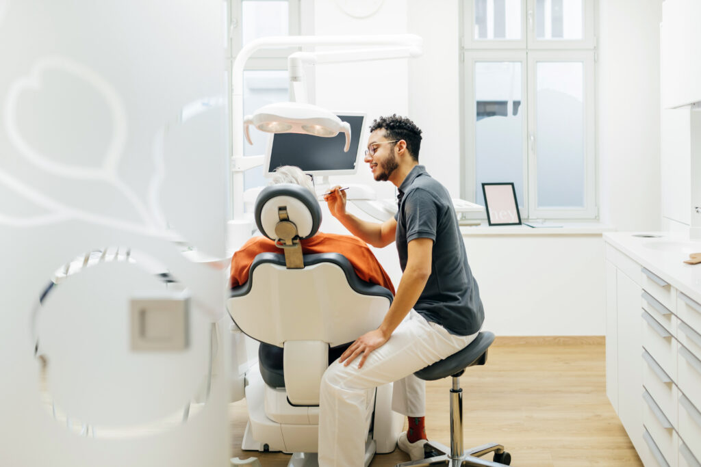 Dentist tending to a patient in office