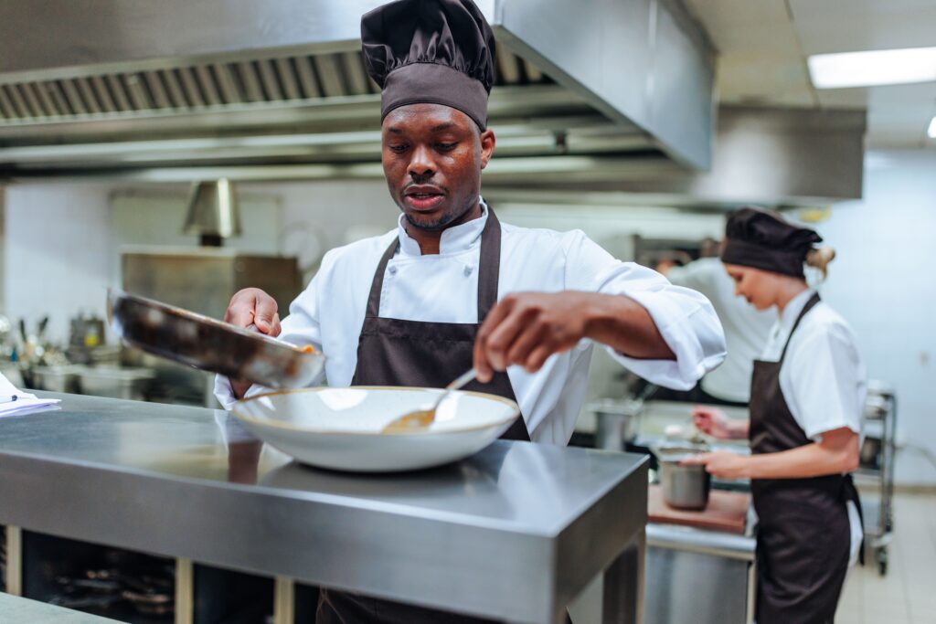 Food service worker plating an order at a restaurant